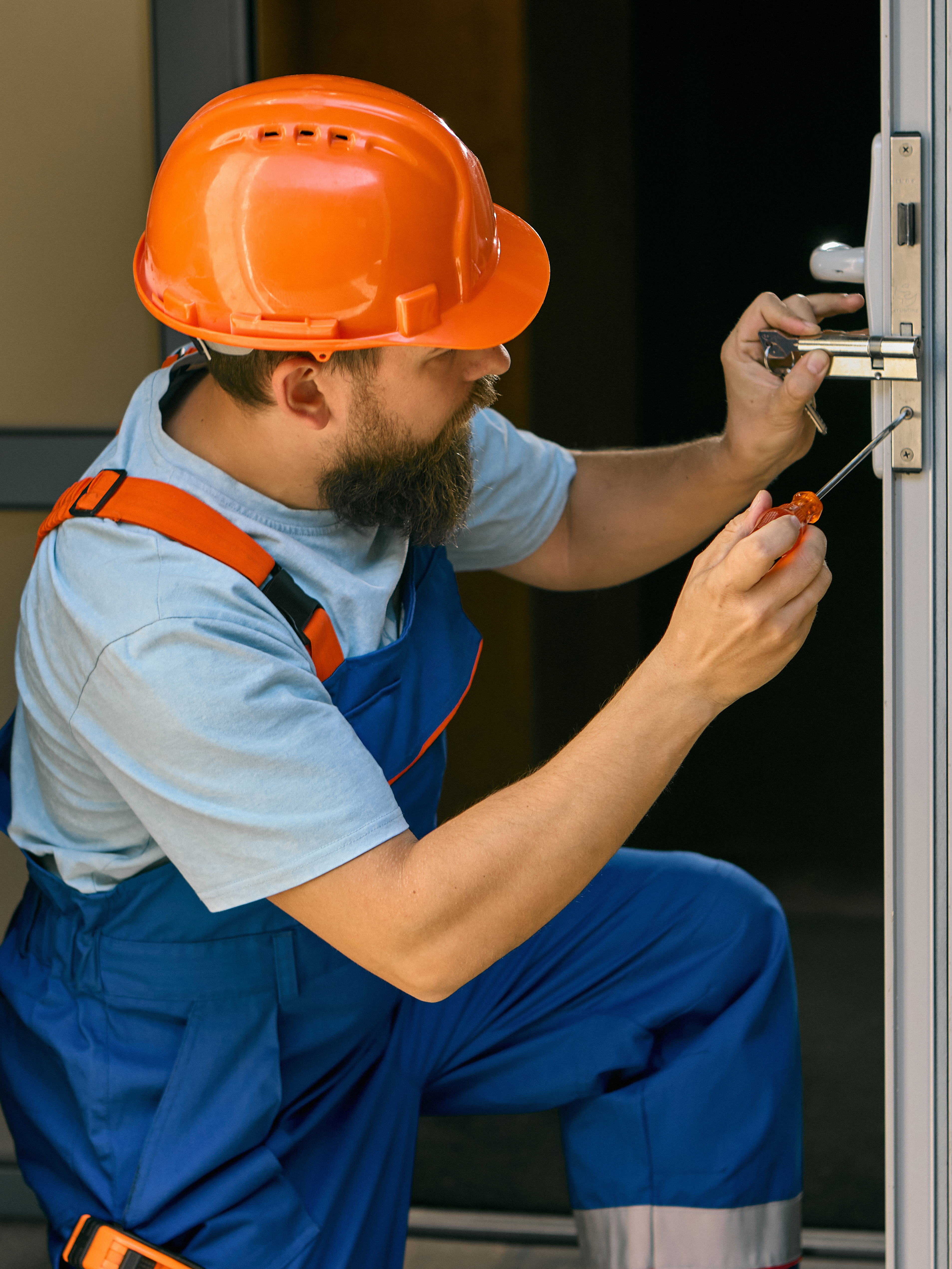 Engineer repairing door handle mechanism in technical area. Concept of HR and recruitment, focusing on skill, craftsmanship, and workplace professionalism.